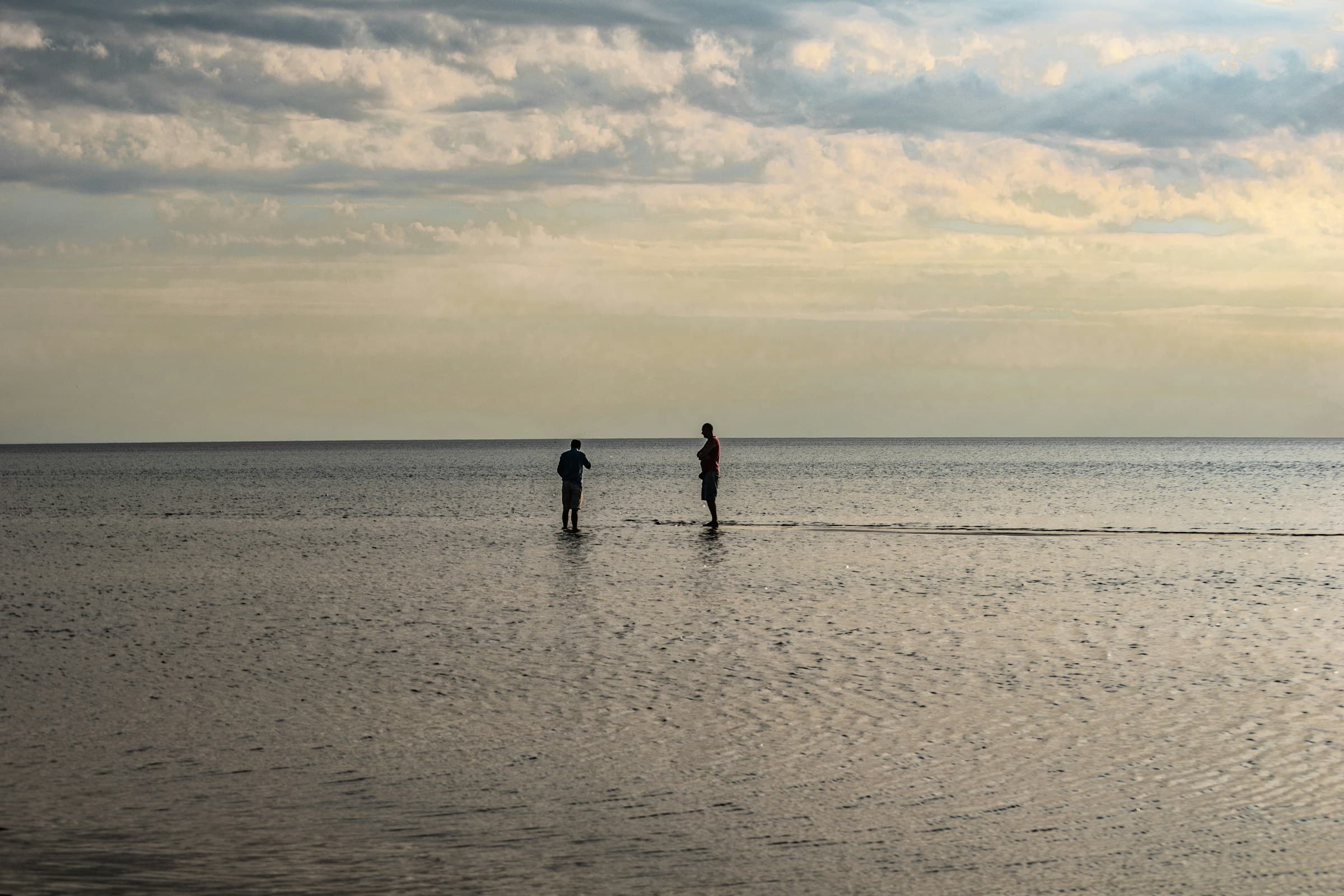 Wading the sandbars of Wasaga Beach at dusk